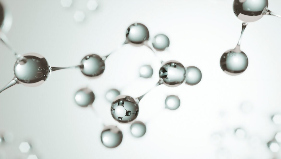 A 3D rendering of peptide molecules, visualized as shiny, reflective spheres connected by molecular bonds, floating against a soft, brightly lit background.