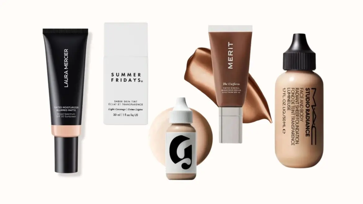 A product flat lay photo displaying five popular sheer foundation and skin tint products arranged in a row on a white background, framed by thin black lines. From left to right: Laura Mercier Tinted Moisturizer Blurred Matte, Summer Fridays Sheer Skin Tint, Glossier Perfecting Skin Tint with a skin swatch, Merit The Uniform Tinted Mineral Sunscreen, and MAC Studio Radiance Face & Body Foundation. All product packaging and labels are visible and legible.